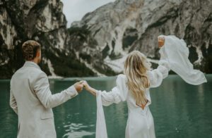 A photo of a couple celebrating after their elopement at Lago Di Braies in the Italian Dolomites