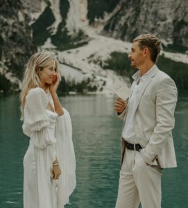 A bride cries as her groom reads his vows at Lago Di Braies in the Italian Dolomites