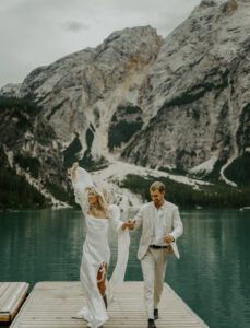A couple celebrates after eloping at Lago Di Braies in the Italian Dolomites