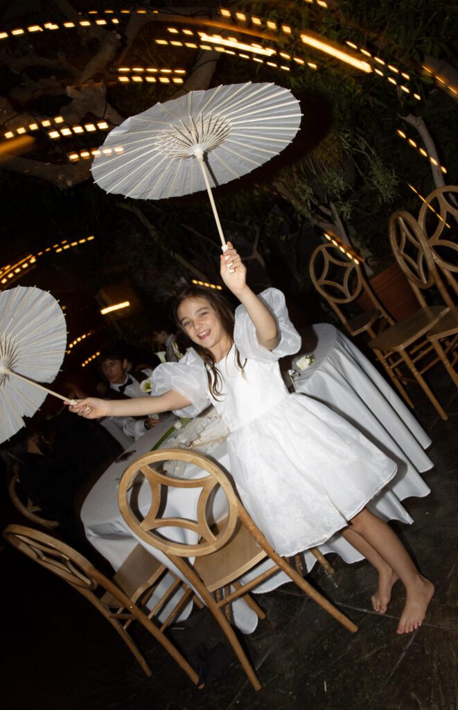 Child dancing during a wedding reception at La Caille wedding venue in Utah, capturing a playful and joyful guest moment