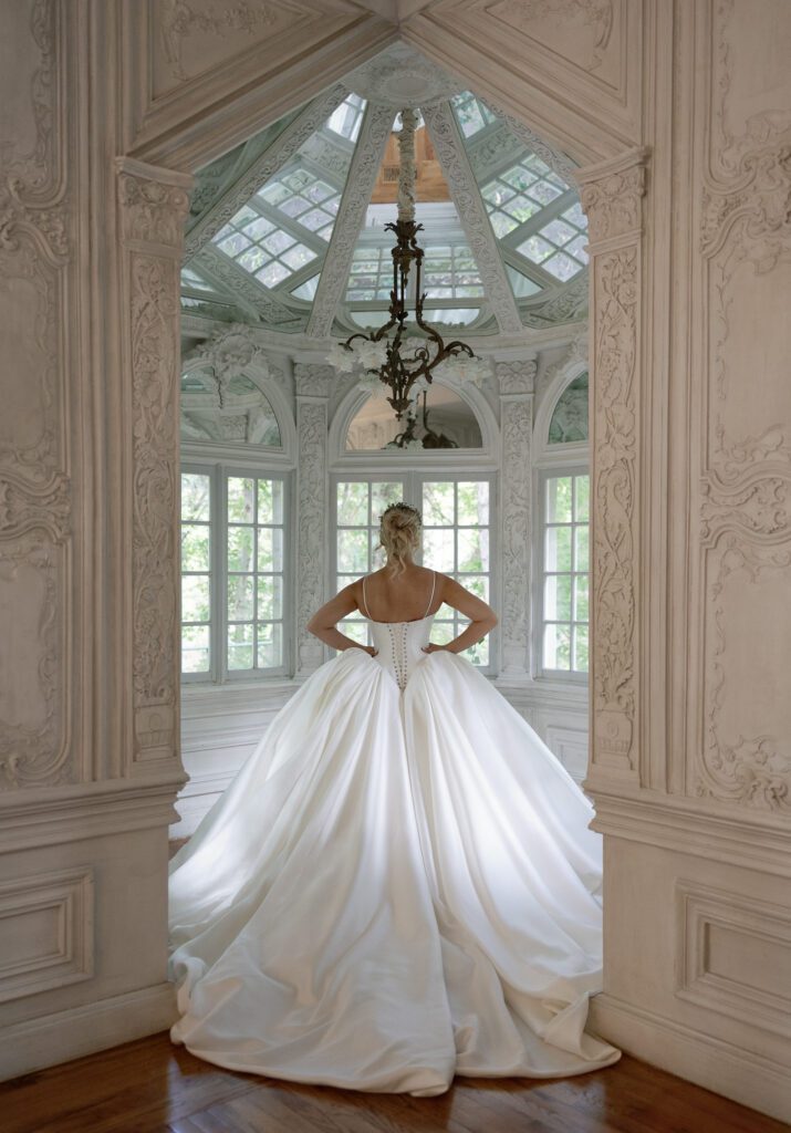 Bride standing in an elegant indoor room at La Caille wedding venue in Utah, showcasing French-inspired architecture and natural light