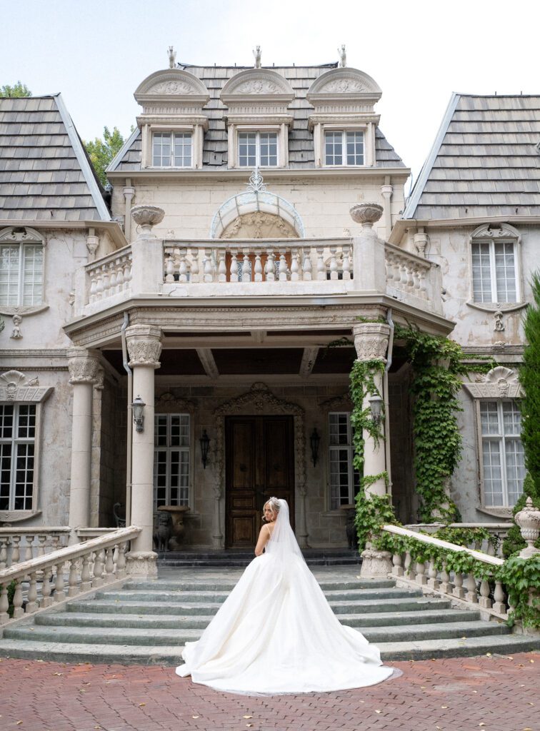 Exterior view of the La Caille wedding venue in Utah, featuring French-inspired stone architecture and classic European details