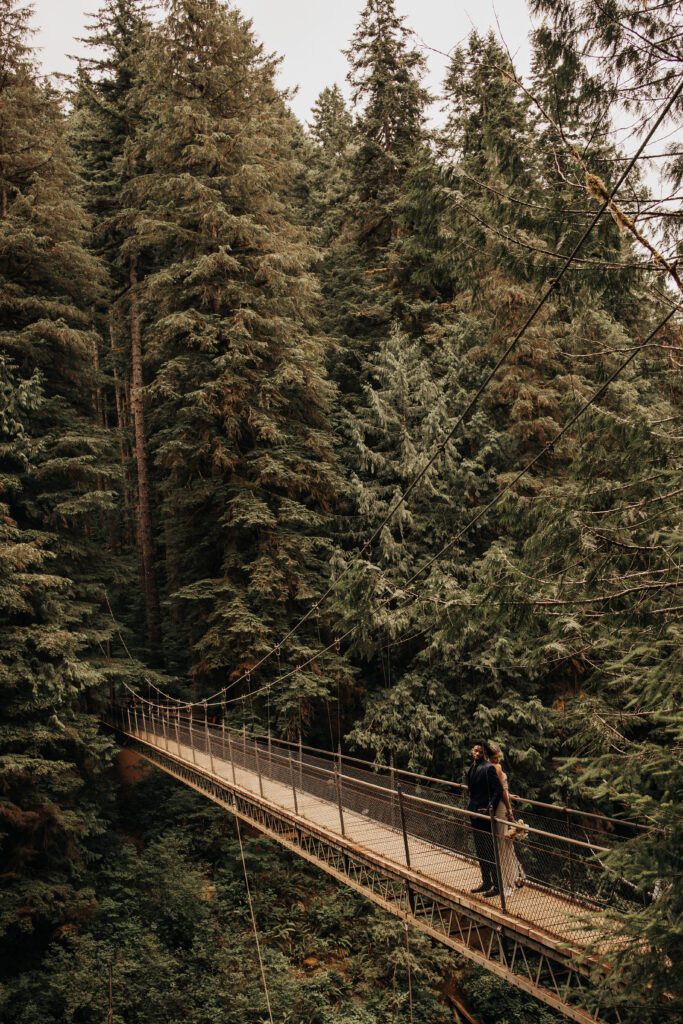 A bride and groom on the Drift Creek Falls suspension bridge in Oregon
