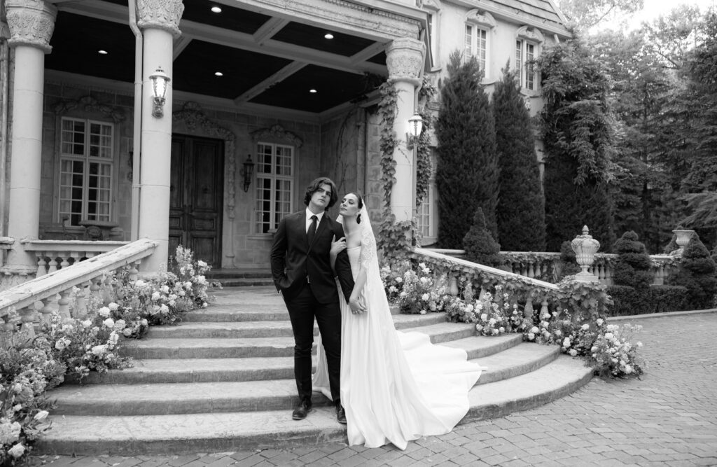 Bride and groom on chateau steps at La Caille during spring wedding portraits