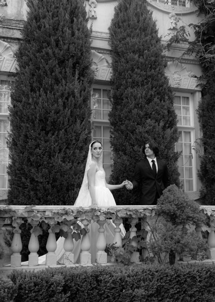Bride and groom on balcony at La Caille chateau during spring wedding