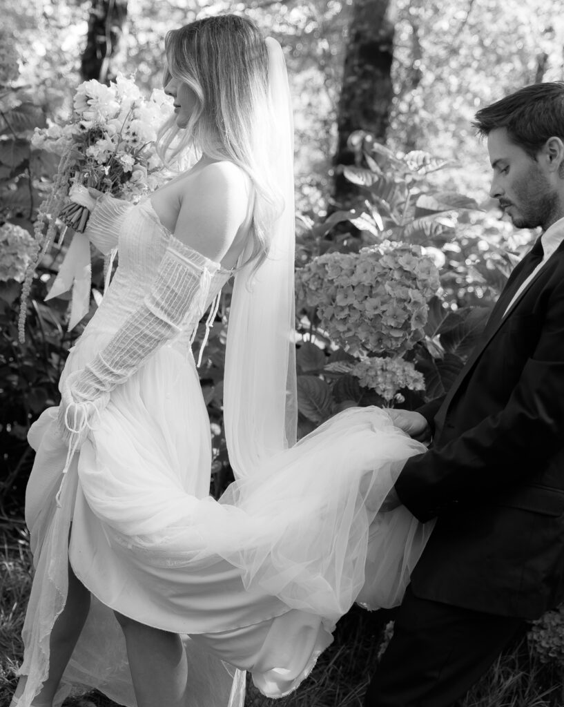 Bride’s flowing wedding dress among hydrangeas at The Hydrangea Ranch in Tillamook, Oregon