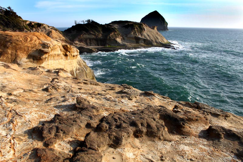 Ocean waves crashing against the cliffs at Cape Kiwanda in Pacific City, Oregon