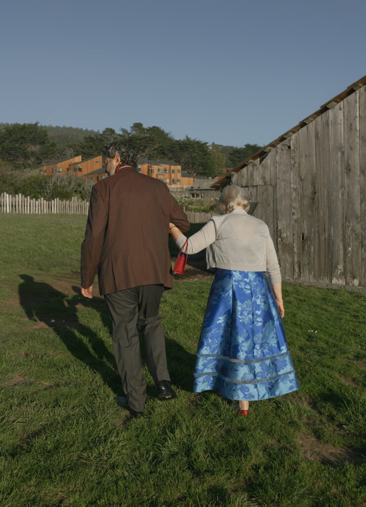 A grandmother and her adult son walk together at sea ranch lodge in california