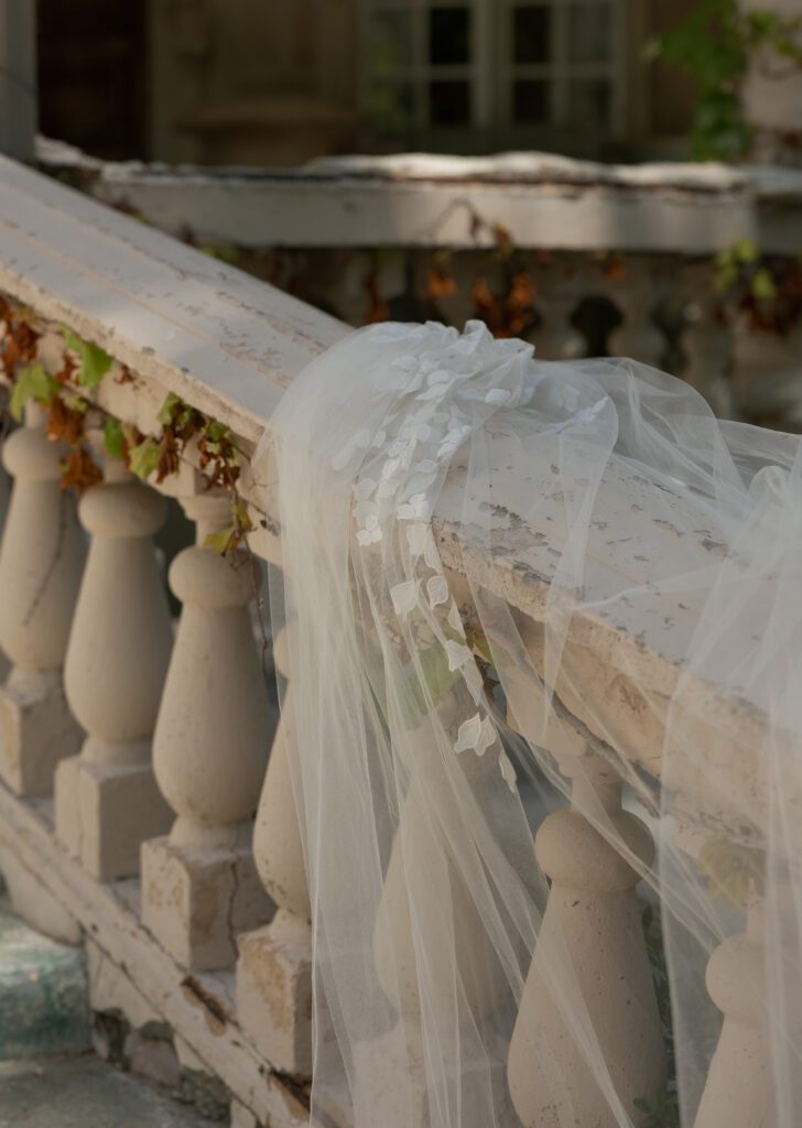 Floral bridal veil draped over a stone balcony at La Caille Utah