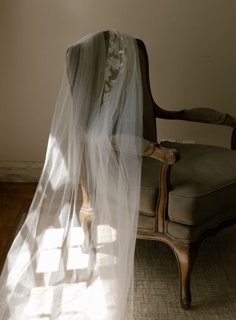 Bridal veil draped over an antique chair inside the Chateau at La Caille