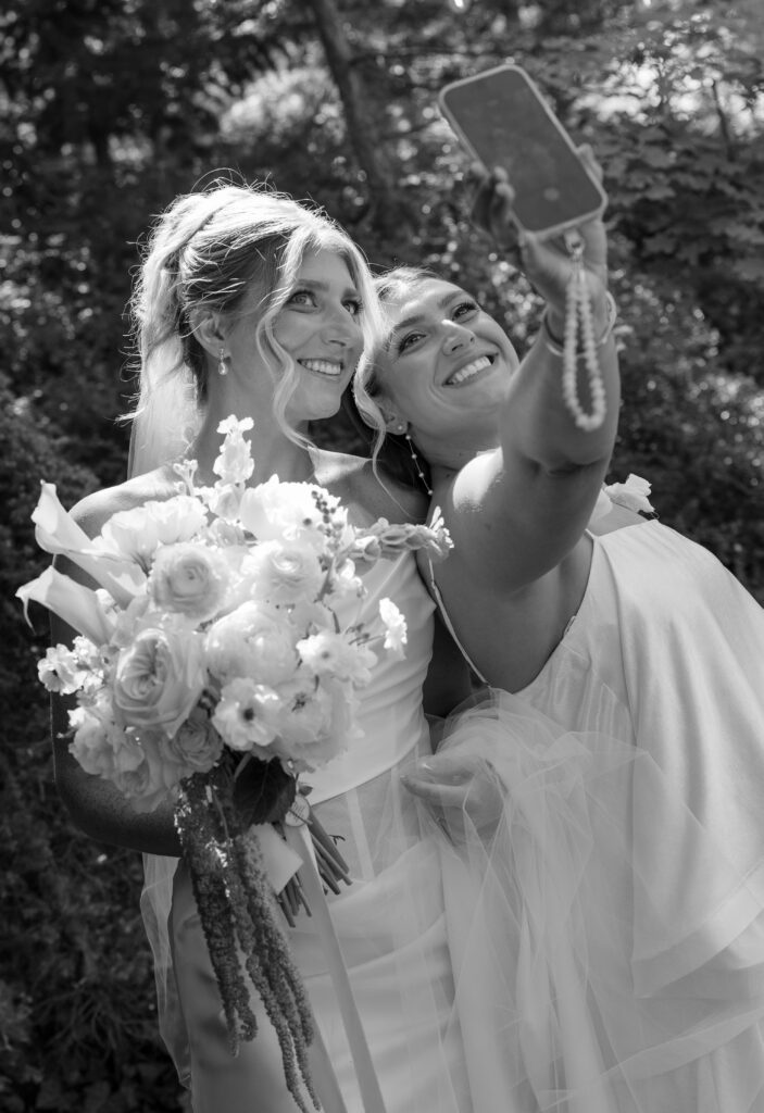 Bride takes a selfie with a guest at la caille utah
