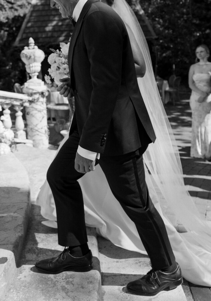 Bride and father walking up stairs to wedding ceremony at la caille utah 