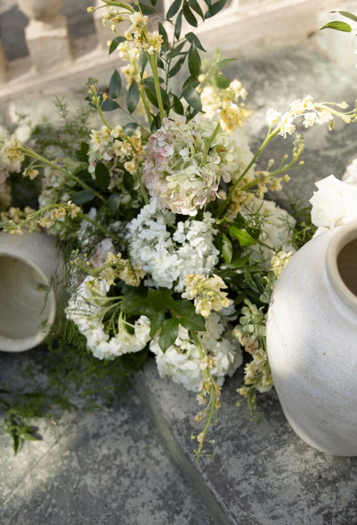 pink and white florals and decorative pots on the stairs of the chateau at la caille utah