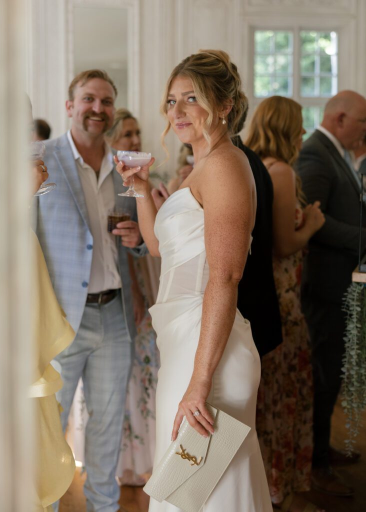 Bride enjoying cocktail hour with guests at her La Caille Utah wedding