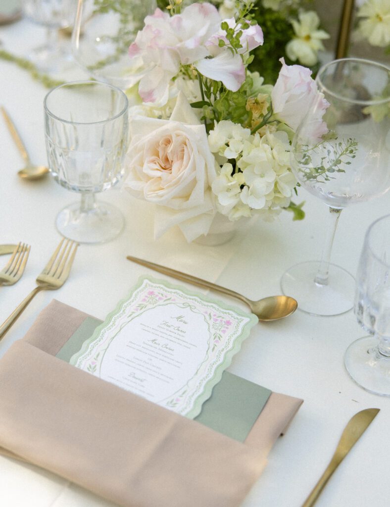 White and blush floral centerpiece at a La Caille garden wedding