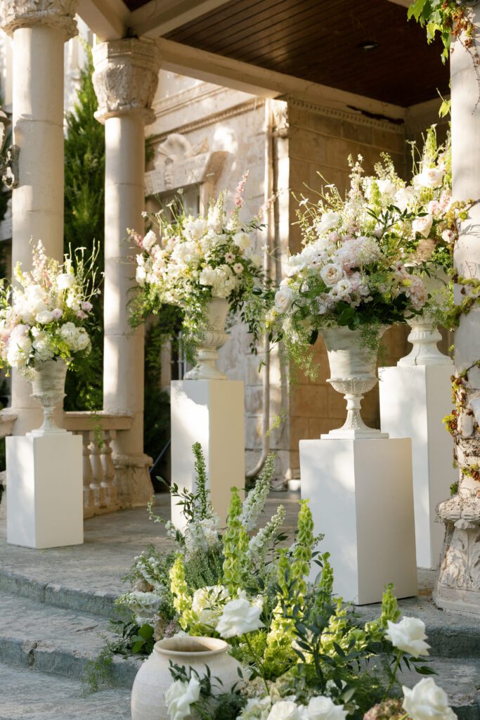 White and pink organic floral ceremony installation outside the Chateau at La Caille Utah